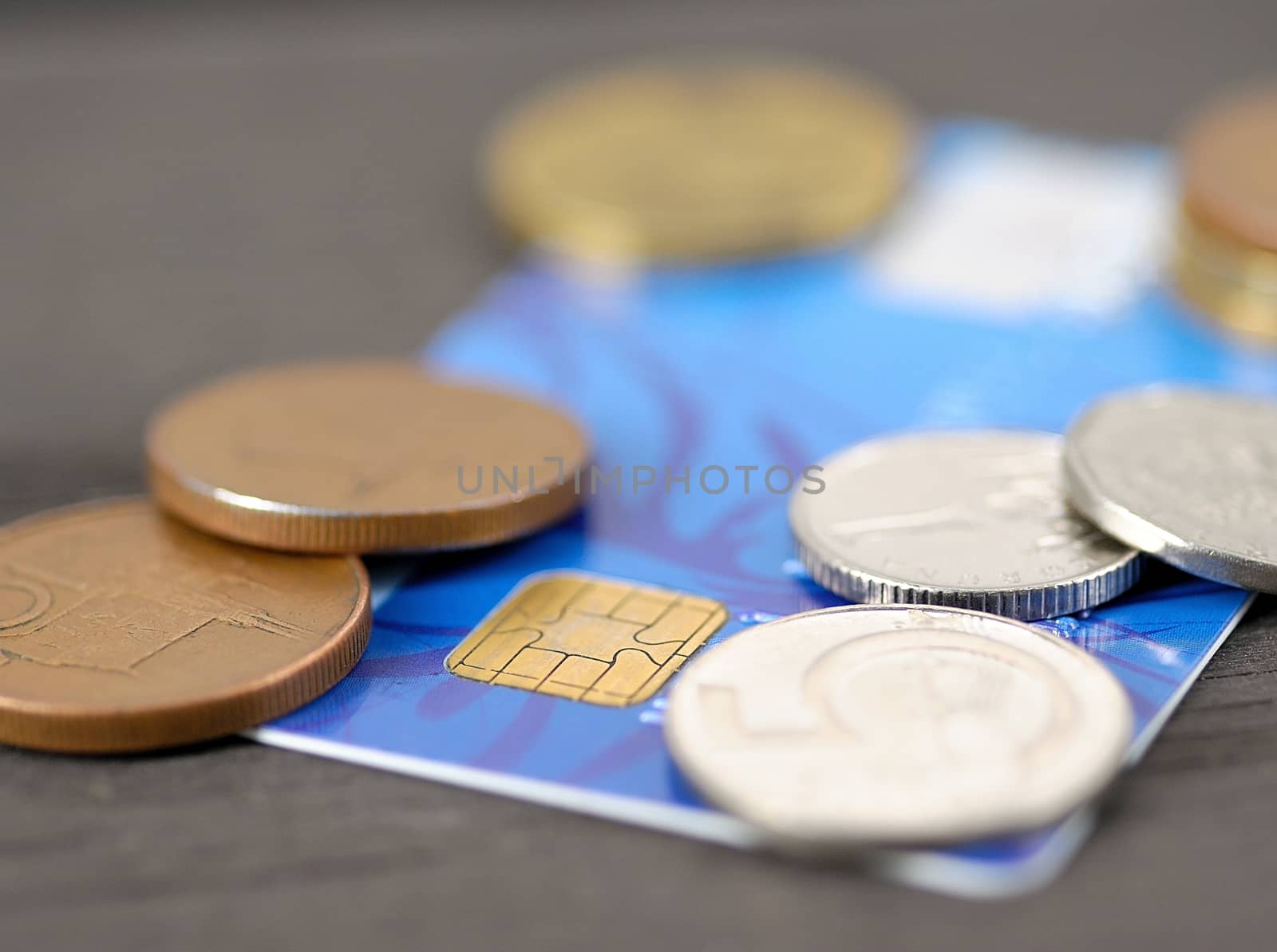 Macro shot of old blue credit card with Czech coins (crown).