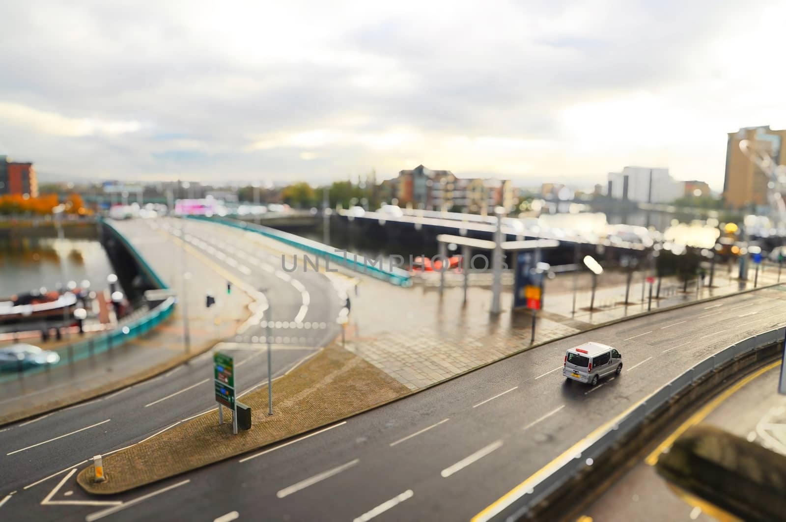 Tilt shift image of city with car on the street.