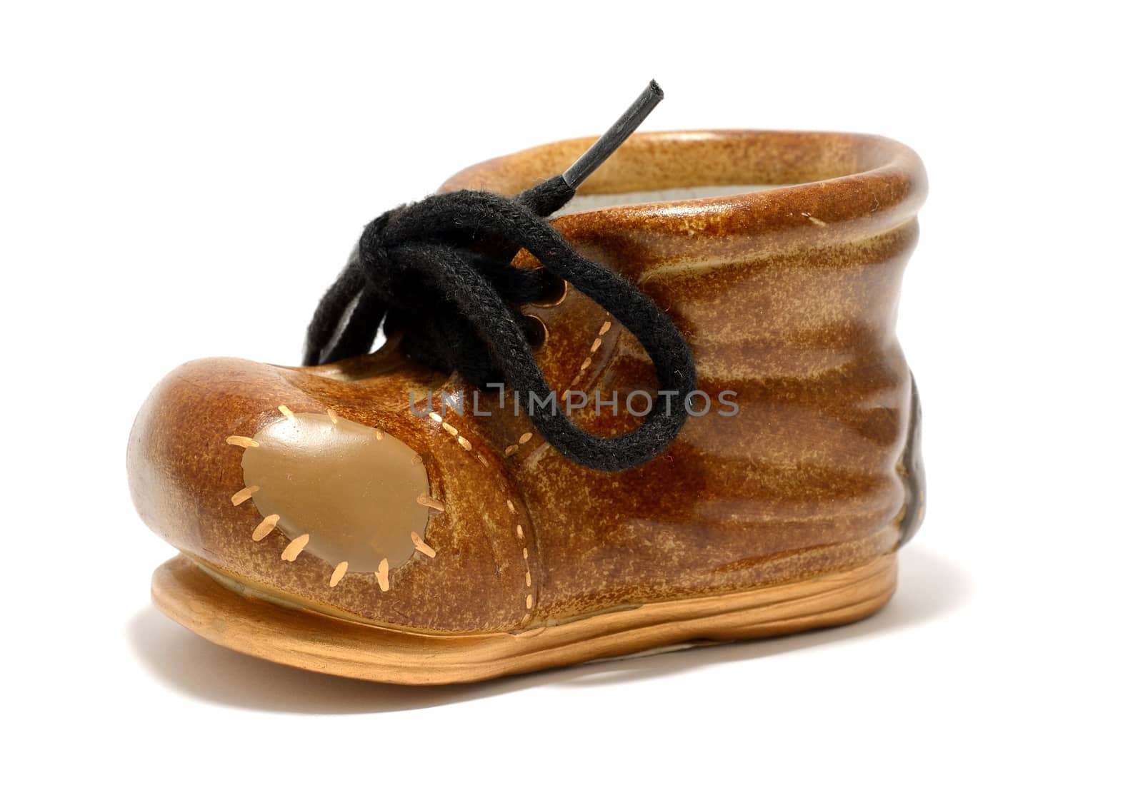 Ceramic decorative small shoe on a white background.