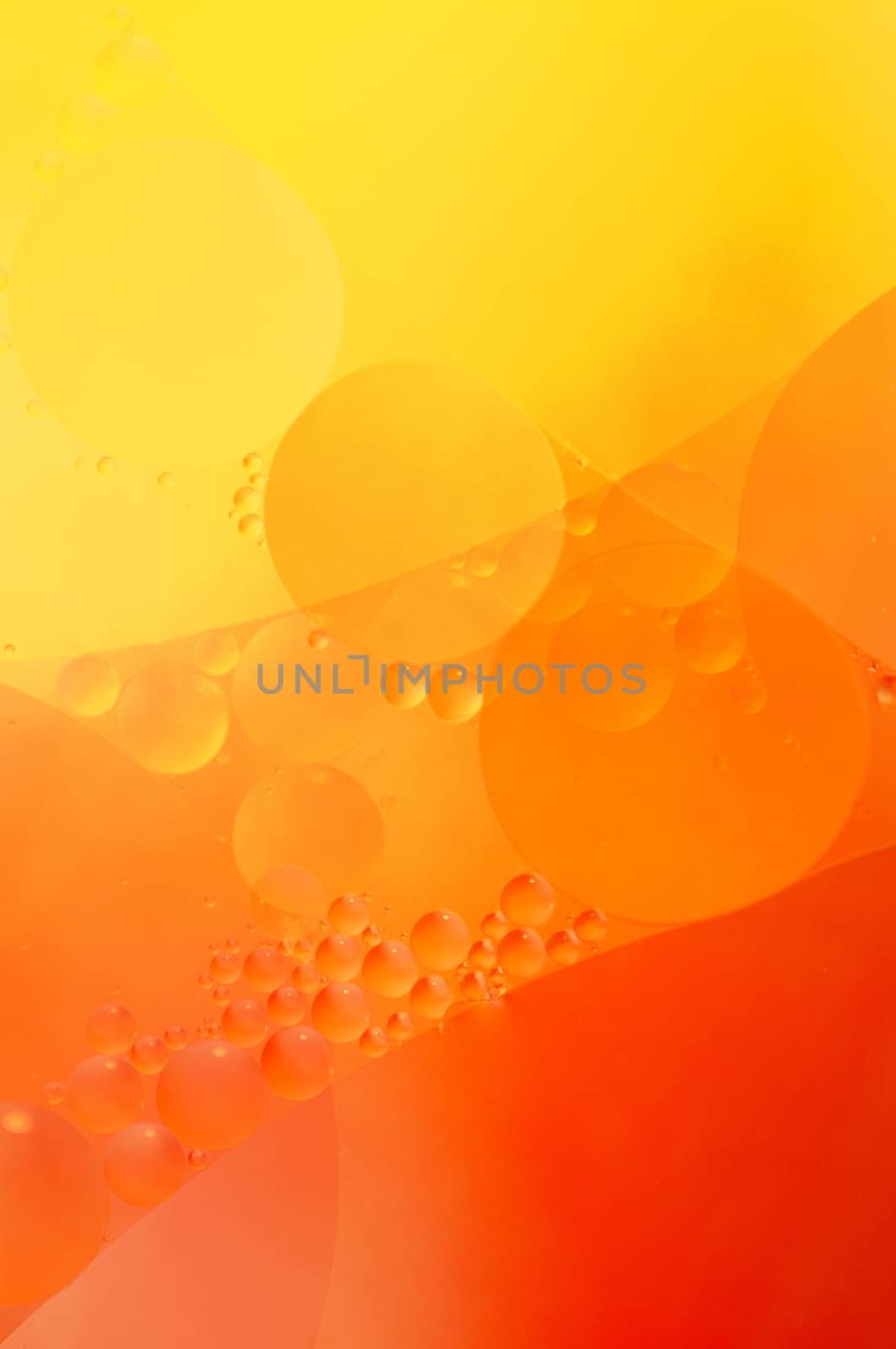 Abstract red, orange background from floating oil bubbles in the water.