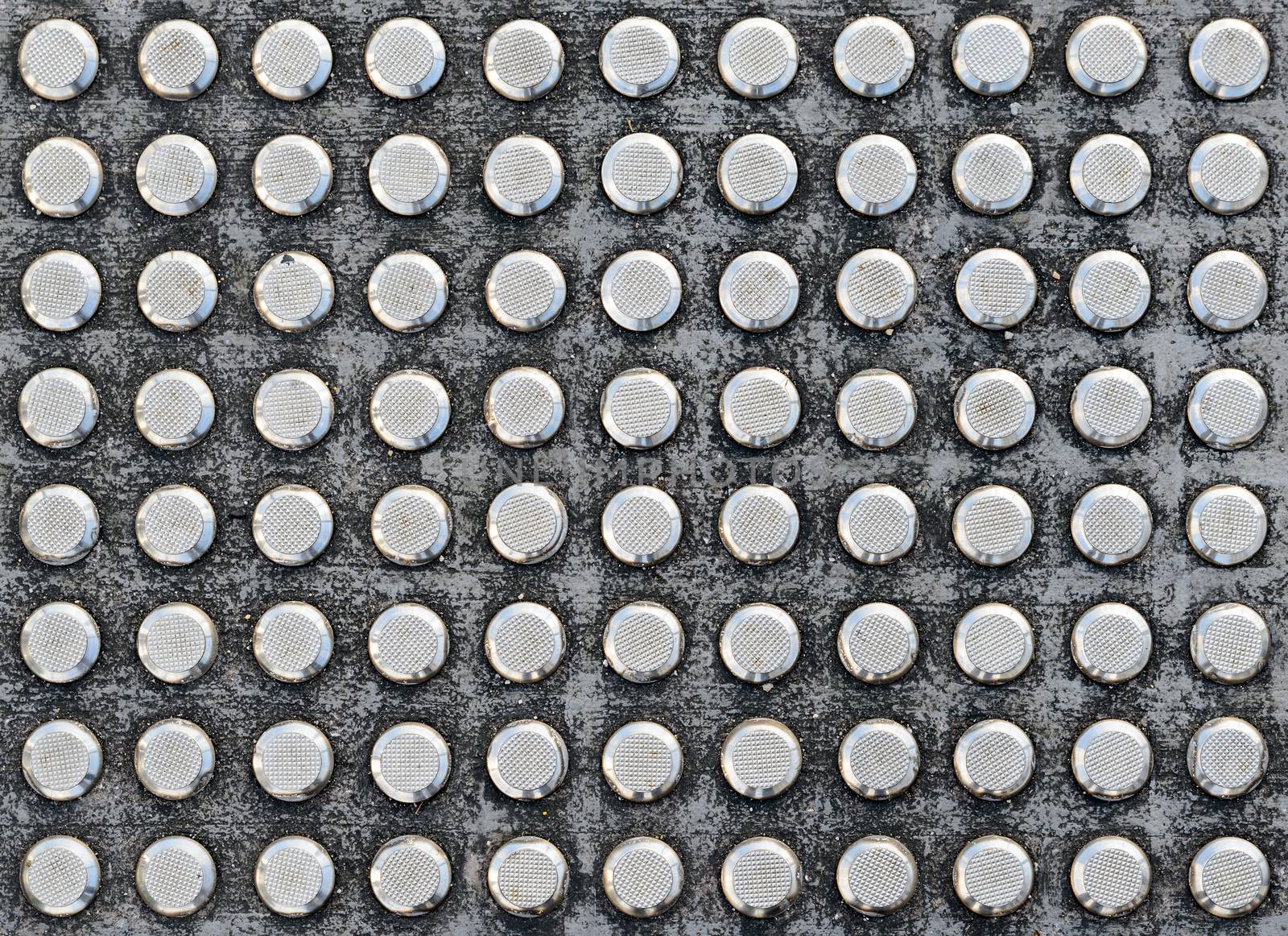 Studs tactile paving textured surface for blind or visually impaired people at a pedestrian crossing