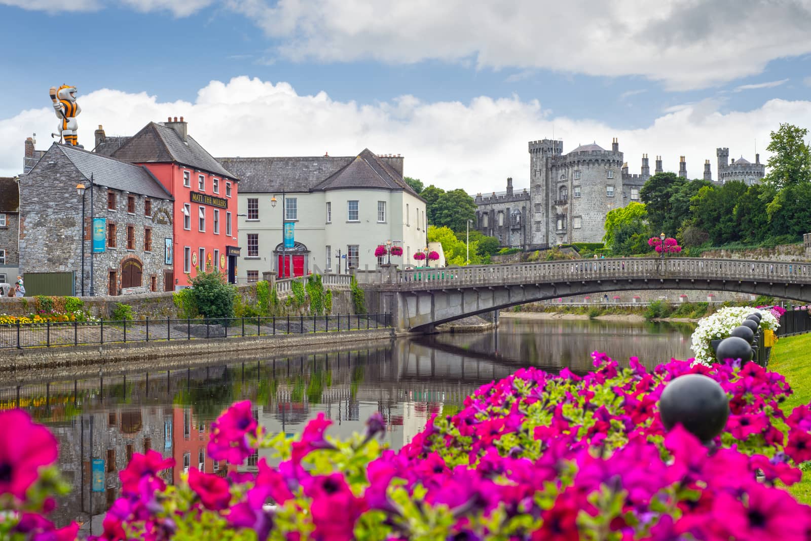 riverside view of kilkenny castle town and bridge by morrbyte