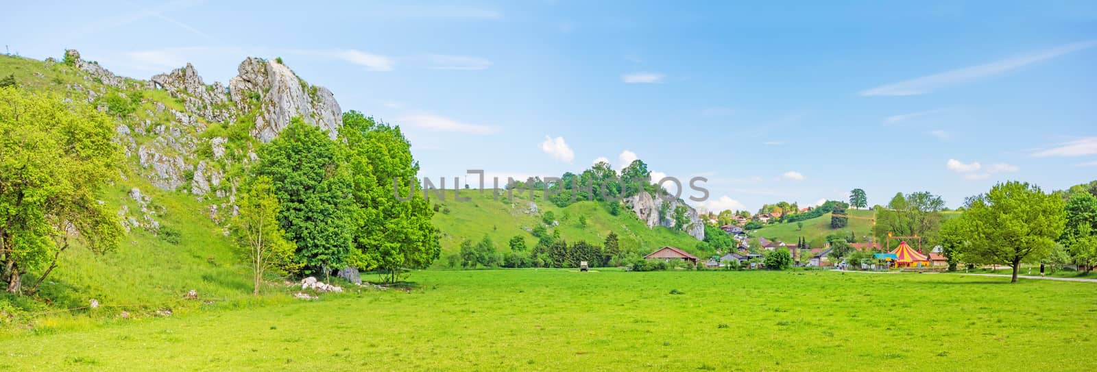 Rural panorama - farm and fair at town Eselsburg - the impressive rocks of valley Eselsburger Tal near river Brenz in foreground - jewel of the swabian alps