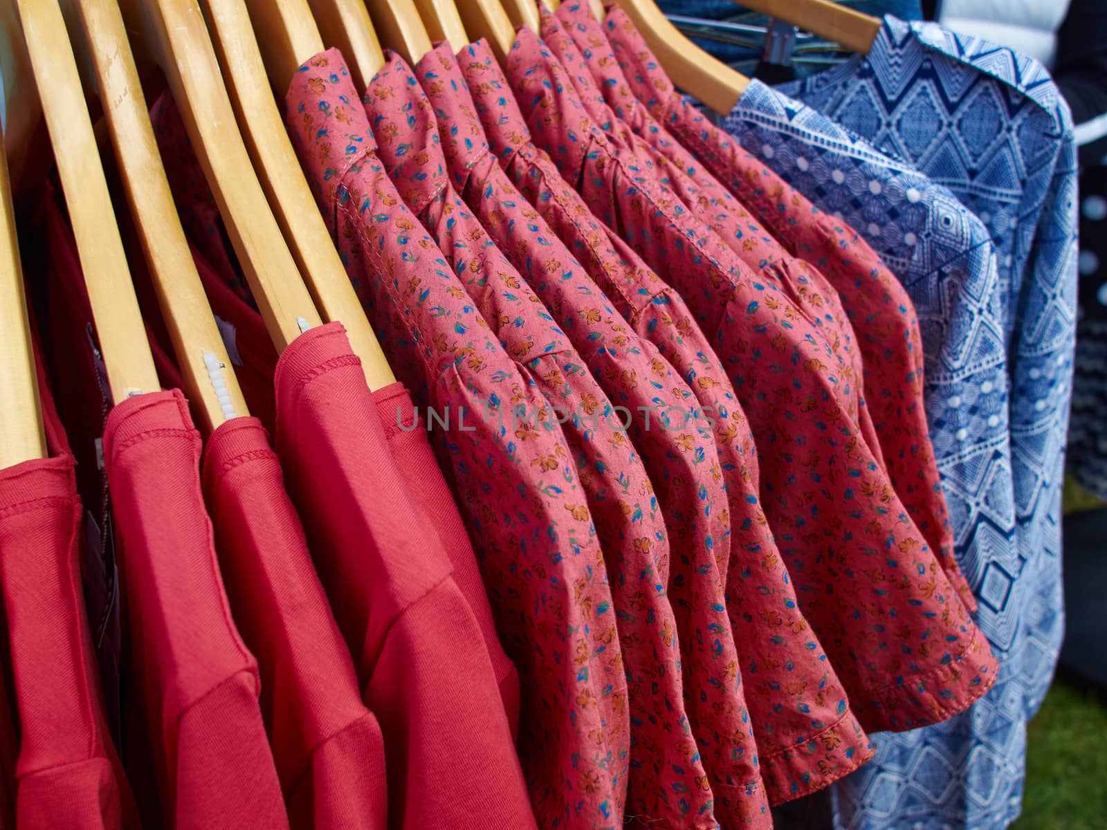 Fashionable design modern blouses on hanger rack display in a store      