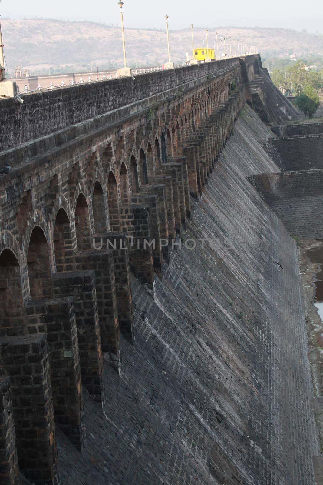 A view of the architecture of an old dam wall made of stones in India.