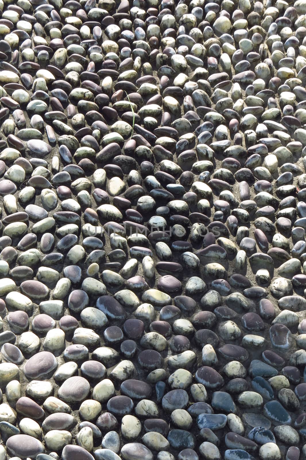 A background with an abstract pattern of well arranged stones on a floor                               