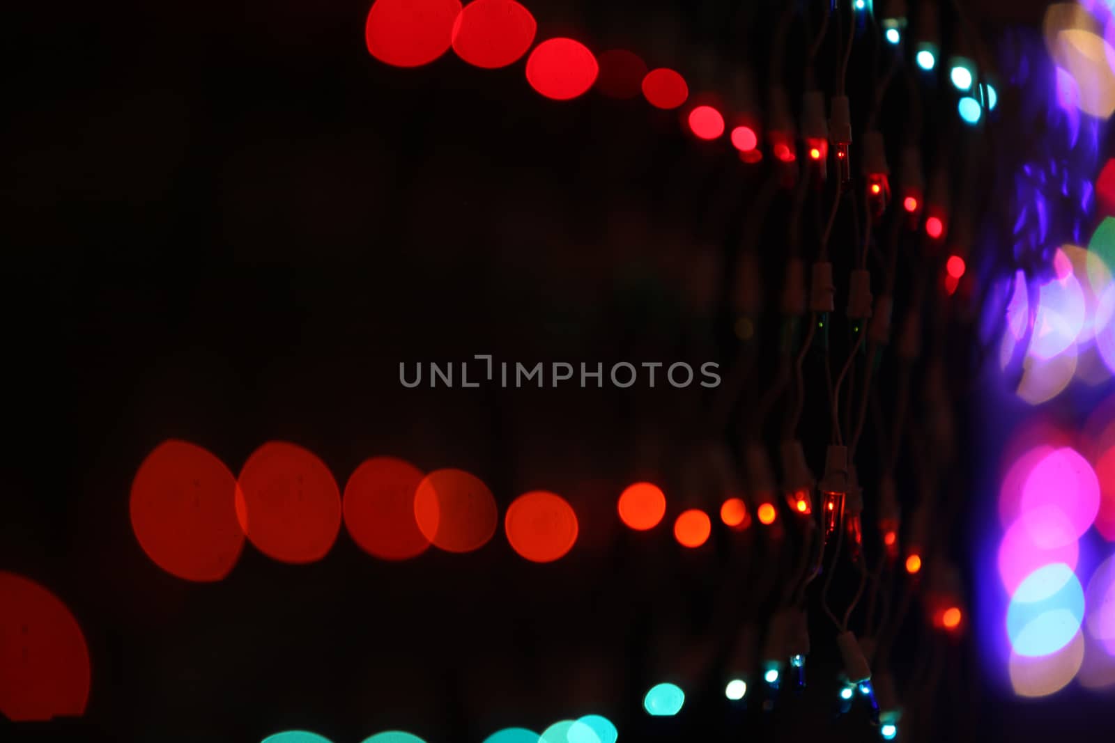 A wire mesh of colorful lights lit for decoration during a festival.