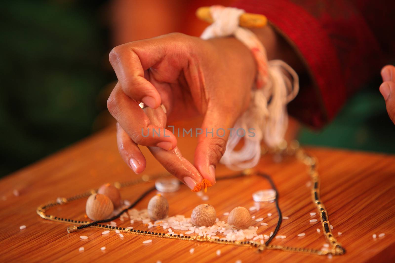 A groom performing a traditional ritual during a hindu wedding in India