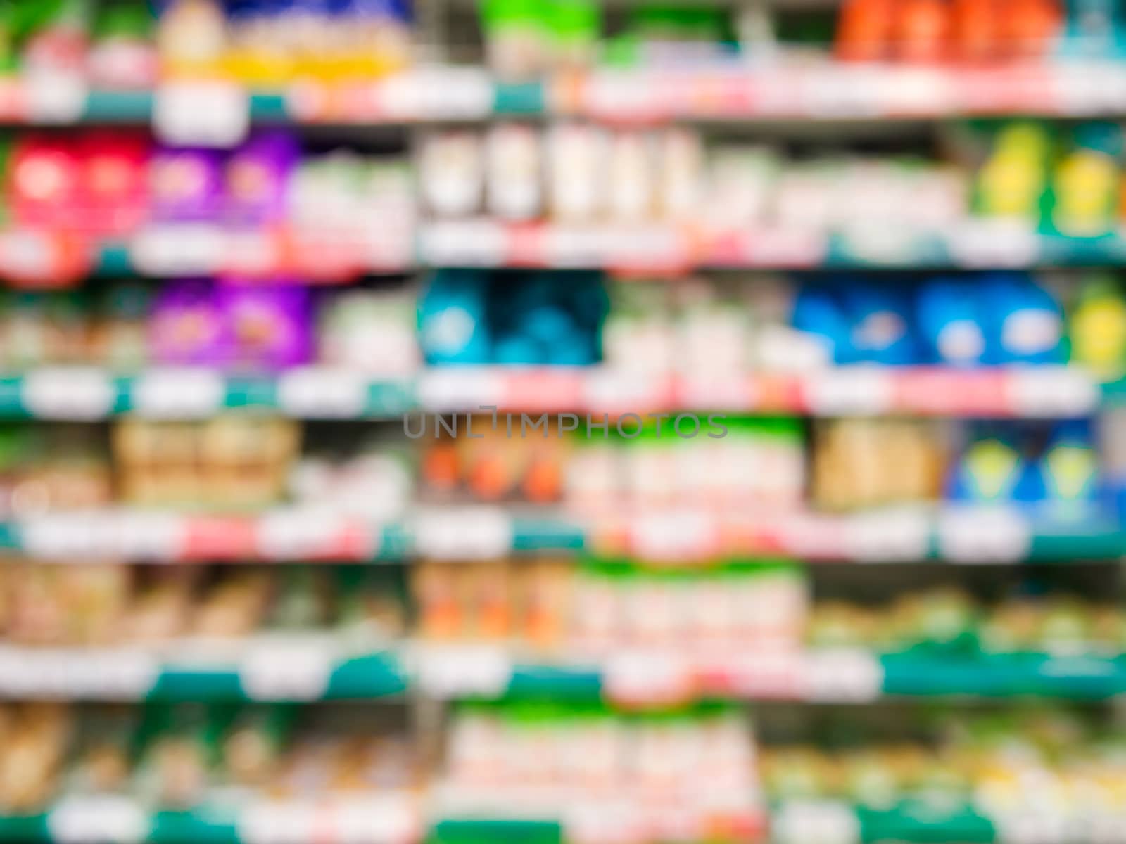 Blurred colorful supermarket products on shelves - Shampoo bottles background with shallow DOF