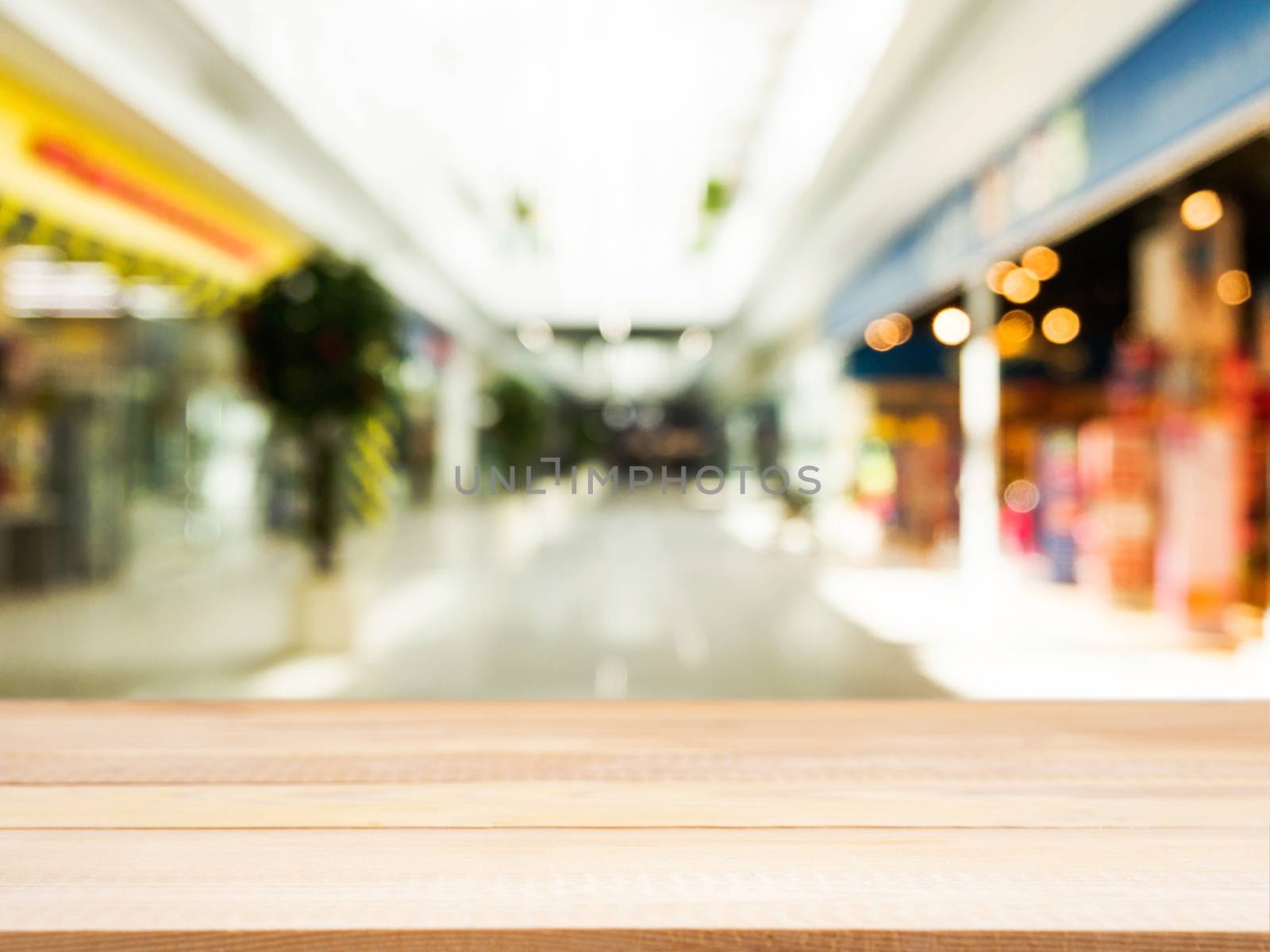 Wooden board empty table in front of blurred background. Perspective light wood over blur in shopping mall - can be used for display or montage your products. Mock up for display of product.