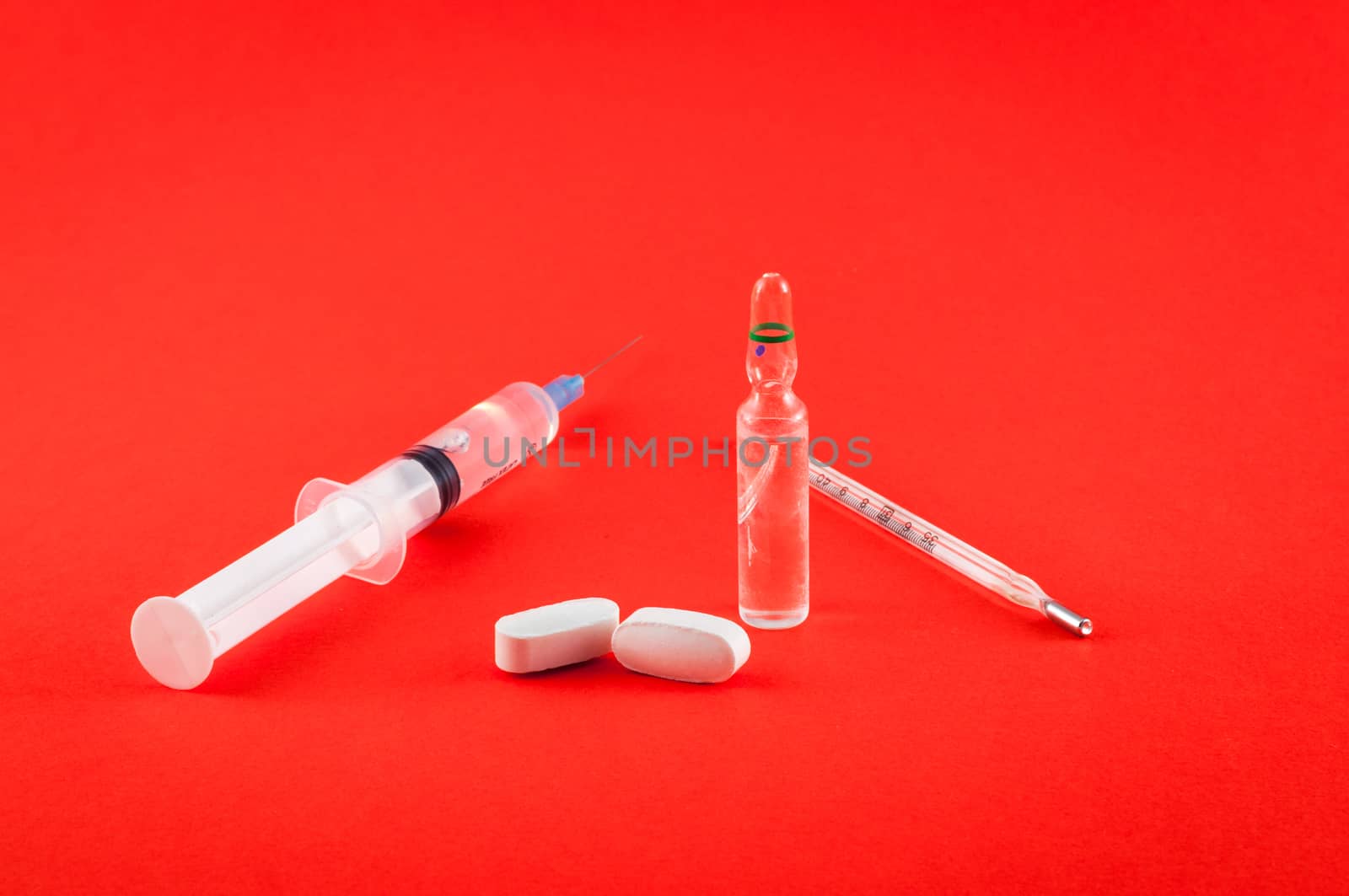 Closeup of medical tools and drugs on colored background