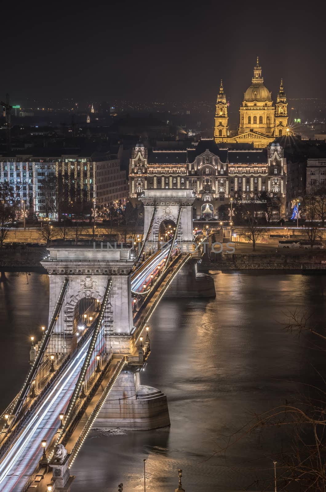 Night View of Chain Bridge over Danube River and St. Stephen's Basilica in Budapest, Hungary. As Seen from Royal Palace in Buda Castle.