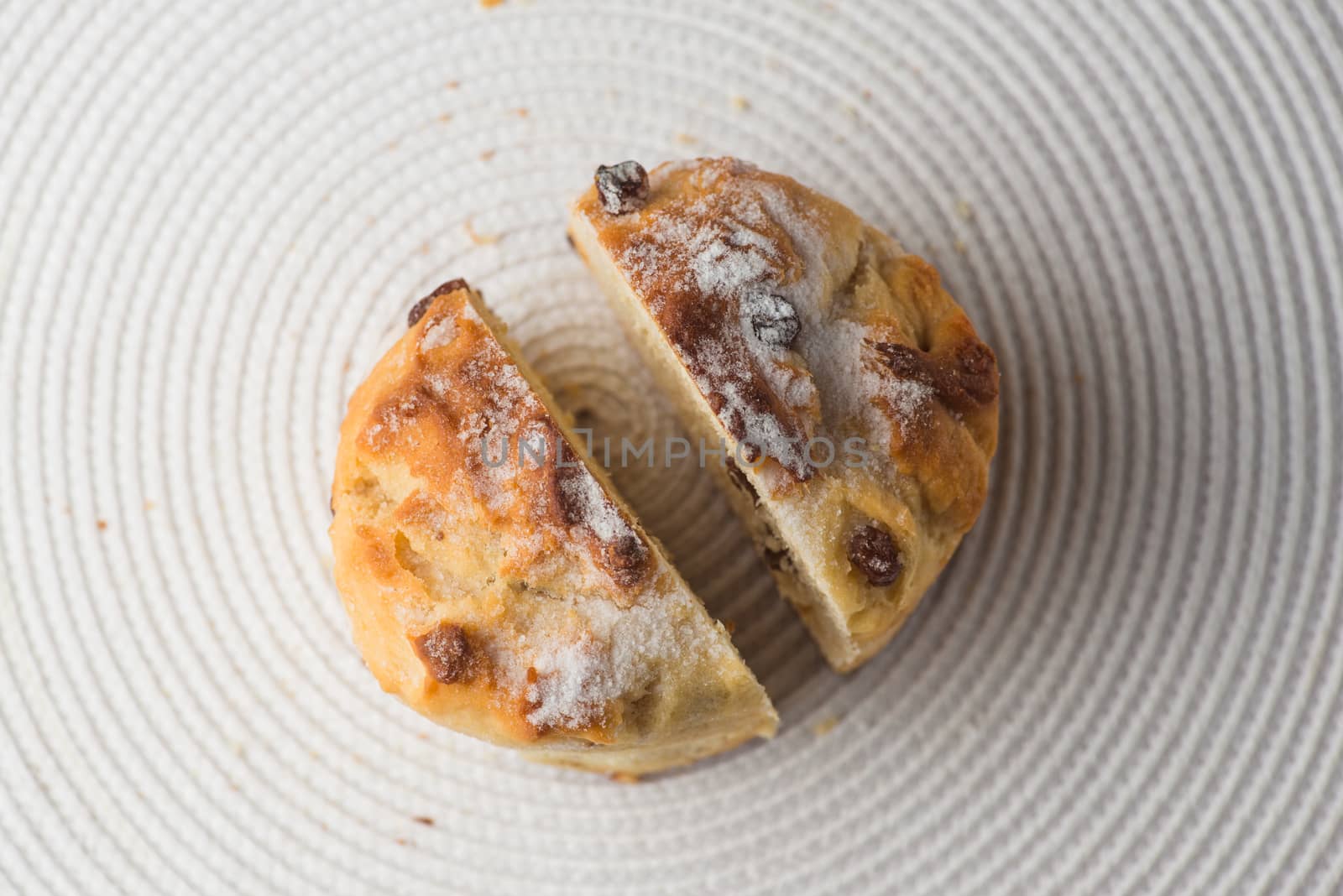 Homemade sliced carrot muffin with empty space on white fabric background. Copyspace top view.