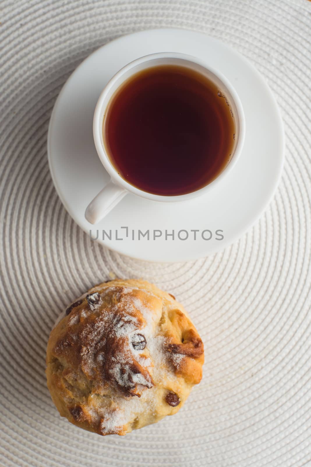 Homemade carrot muffin with cap of tea and lemon on white fabric background. top view by skrotov