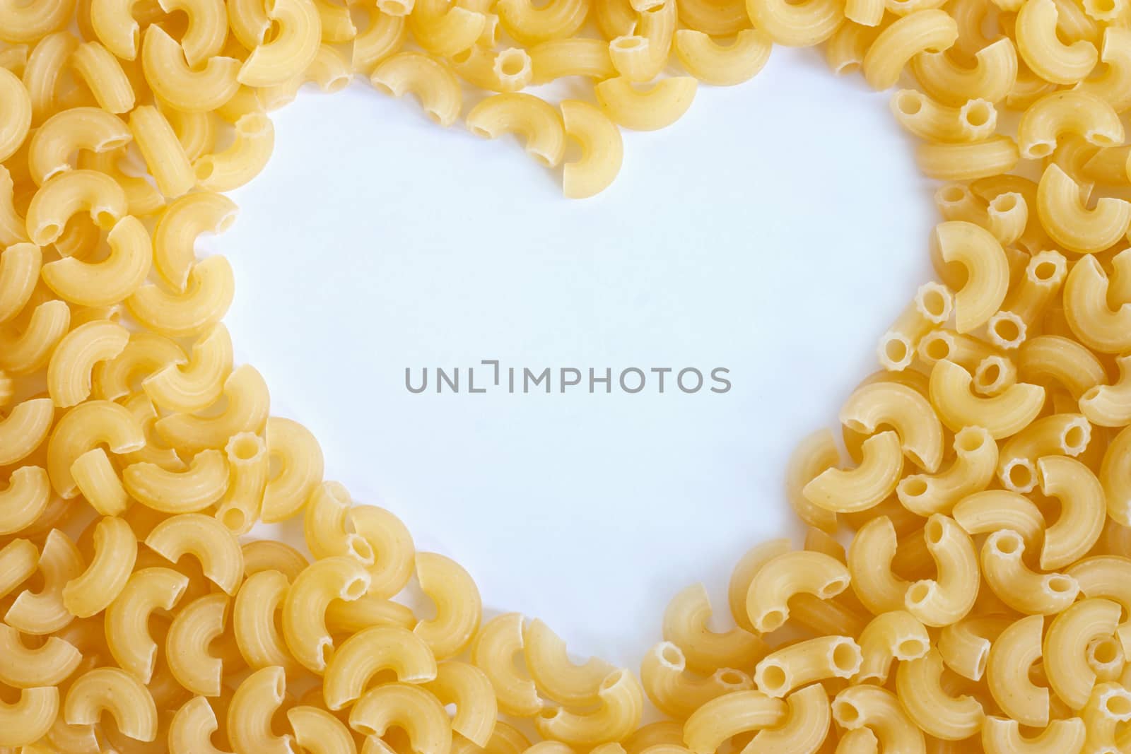 Macaroni pipe form with copy space in heart shape by ekachailo