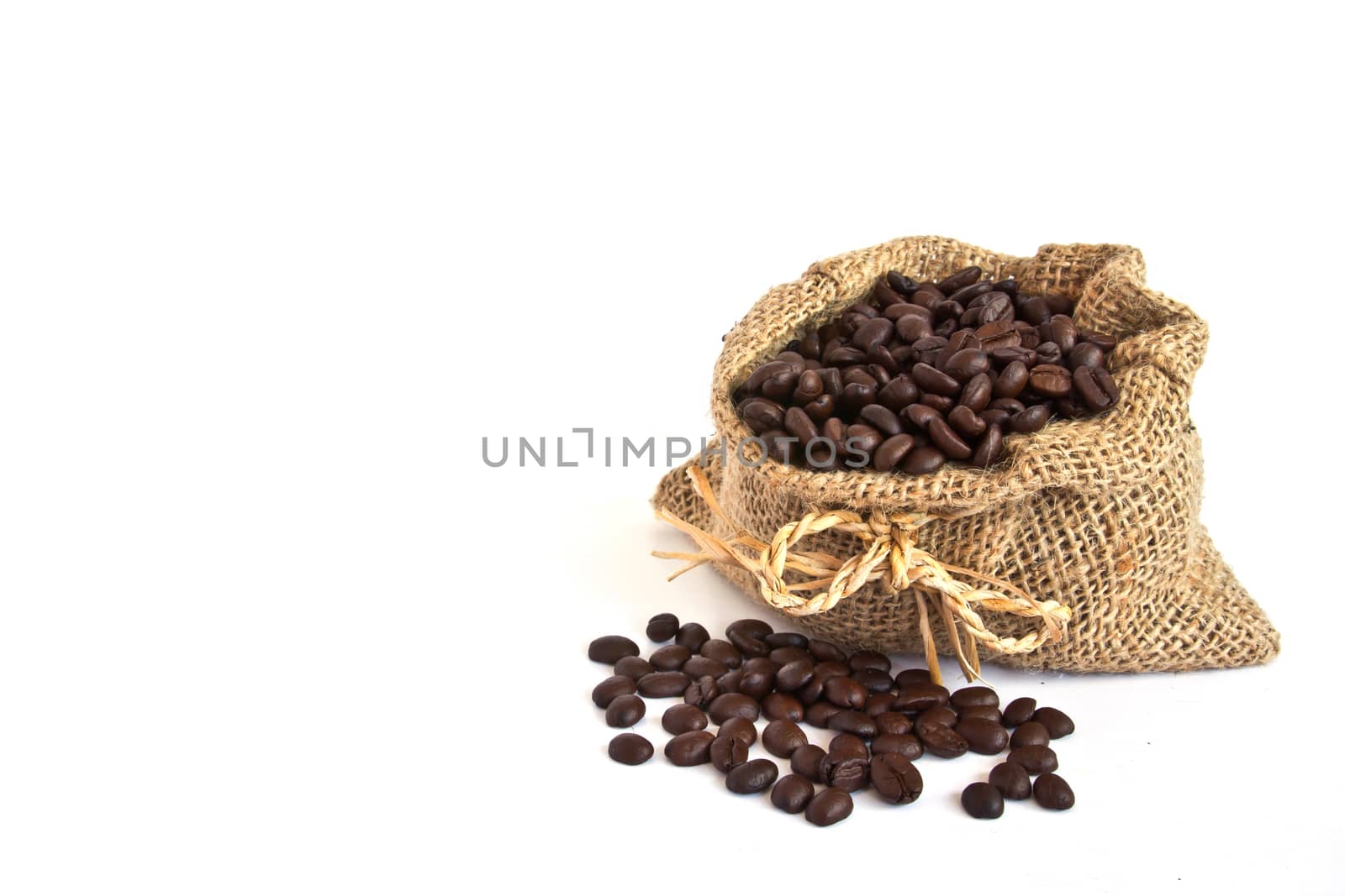 Coffee beans in canvas sack on white background
