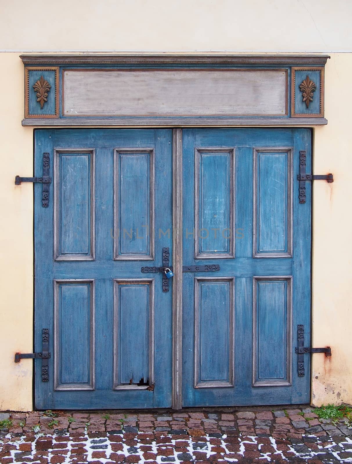 Old blue antique wooden door with padlock.