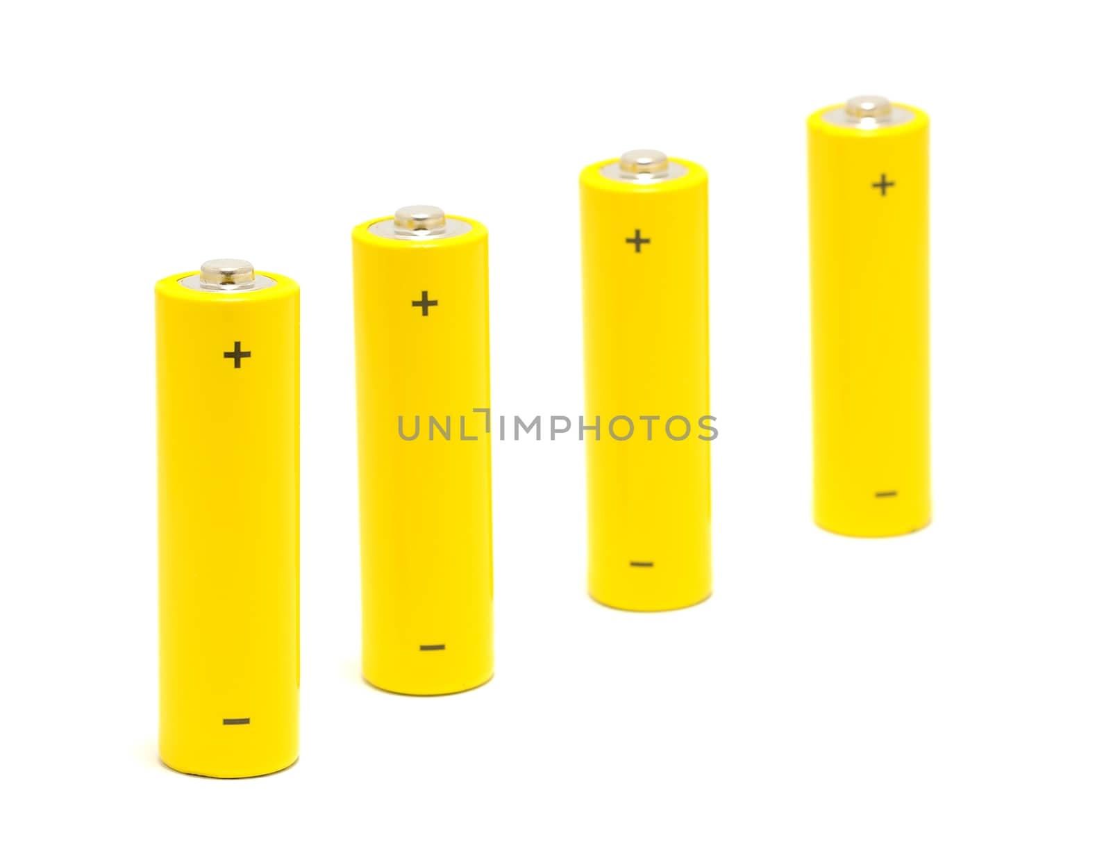 Row of yellow AA size batteries on a white background.