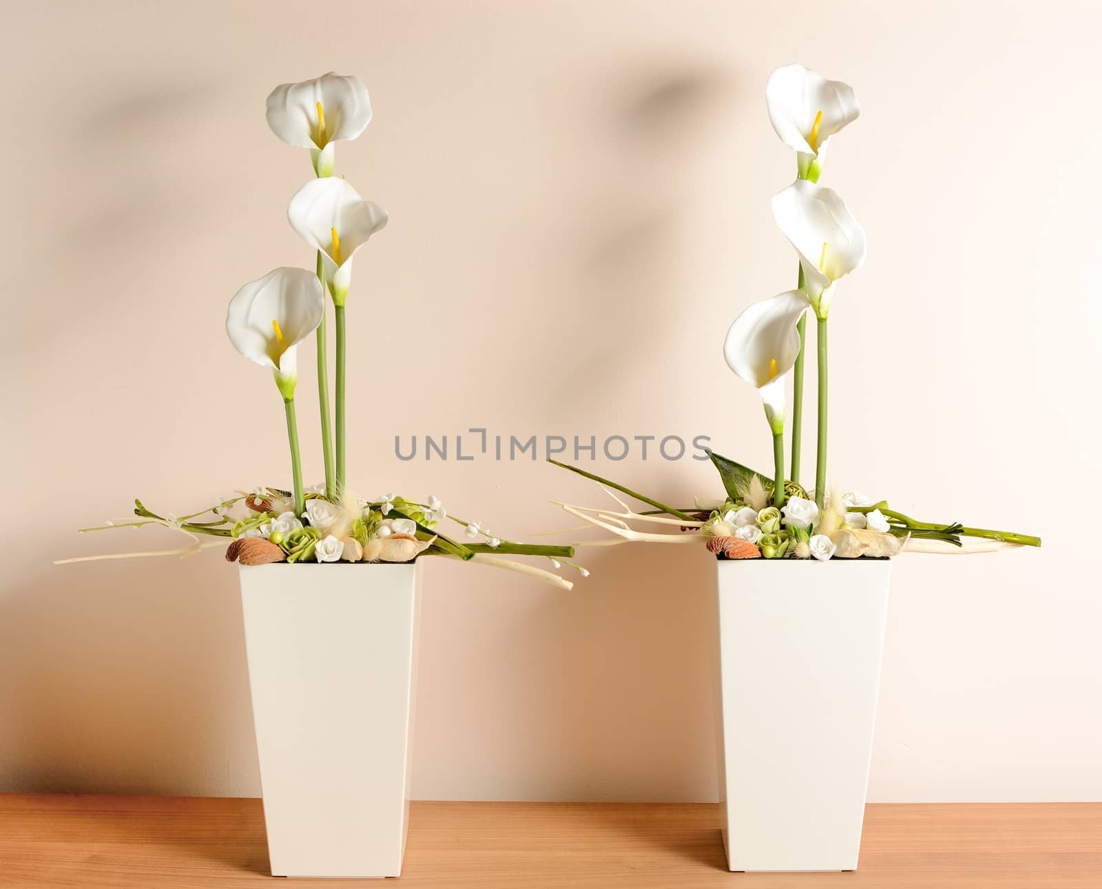 Interior decoration, decorative white calla in the white flowerpot.