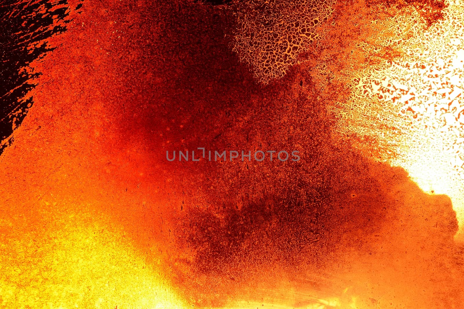 Grunge black orange background made from fire and dirty fireplace window.