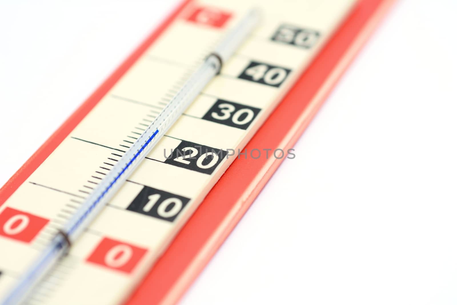 Old vintage red thermometer on a white background.