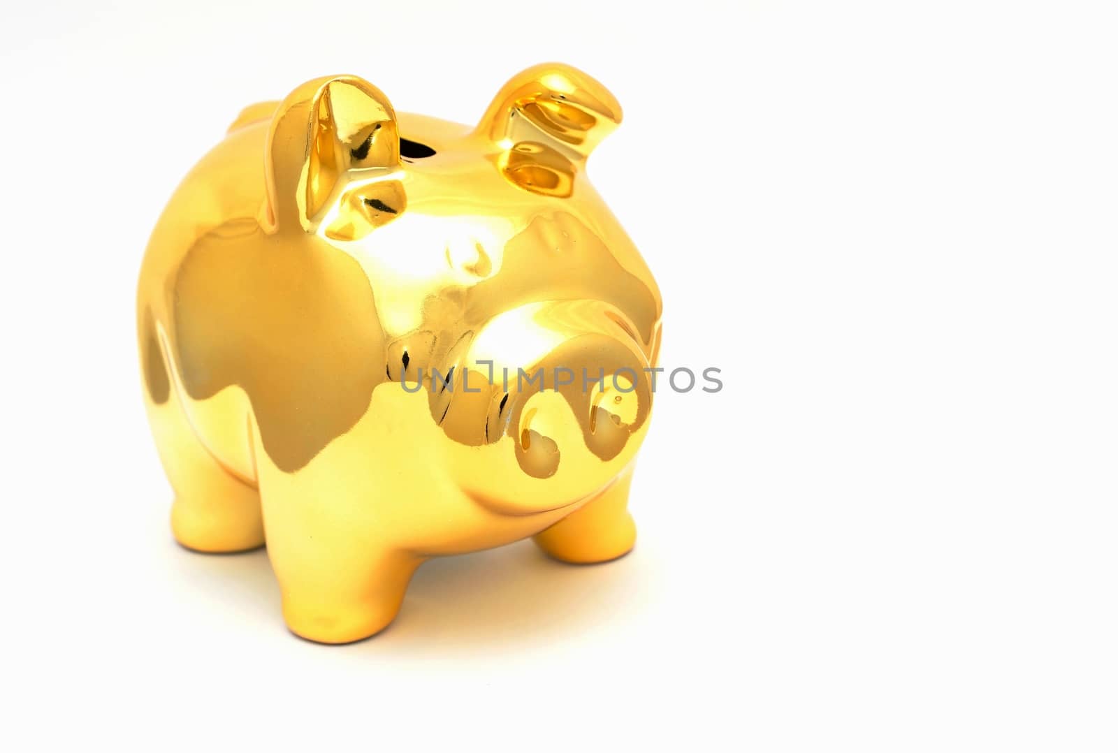 Golden piggy bank placed on a white background.