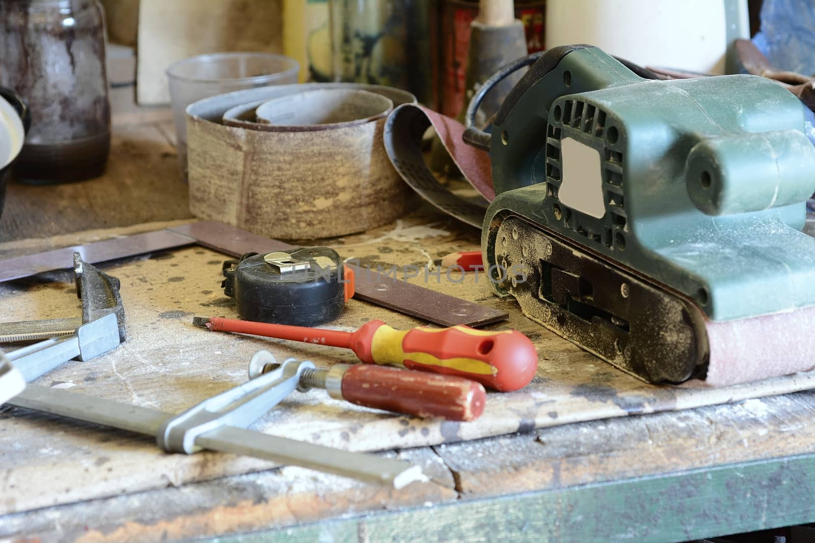 Tools on the workbench, screwdriver, meter and grinder.