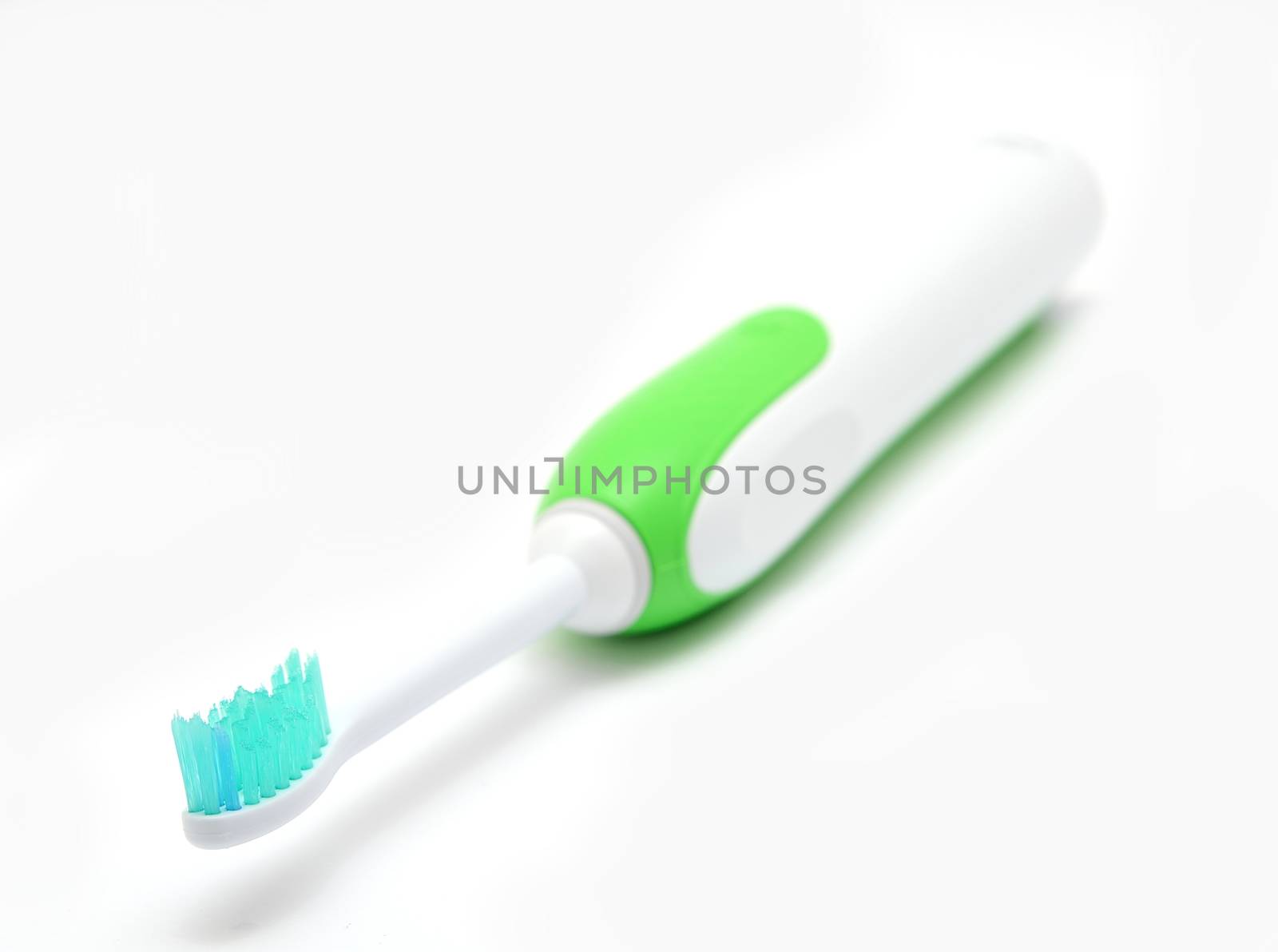 Electric toothbrush on a white background, closeup shot.