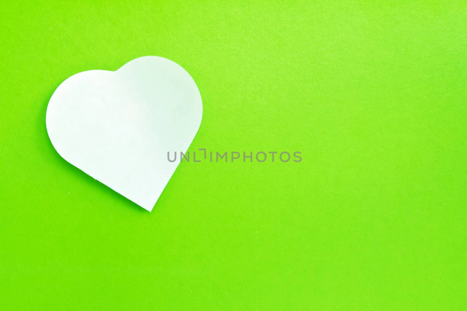 White note paper attached on green background  by ekachailo