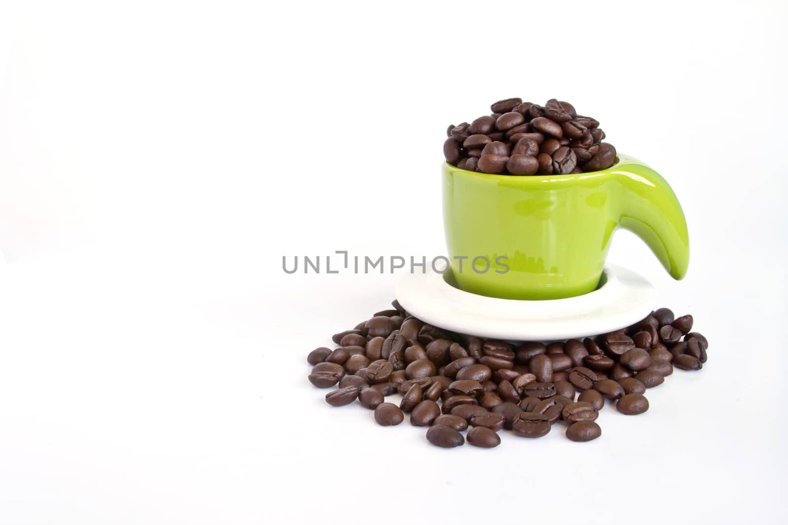 Coffee beans in green cup on white background by ekachailo