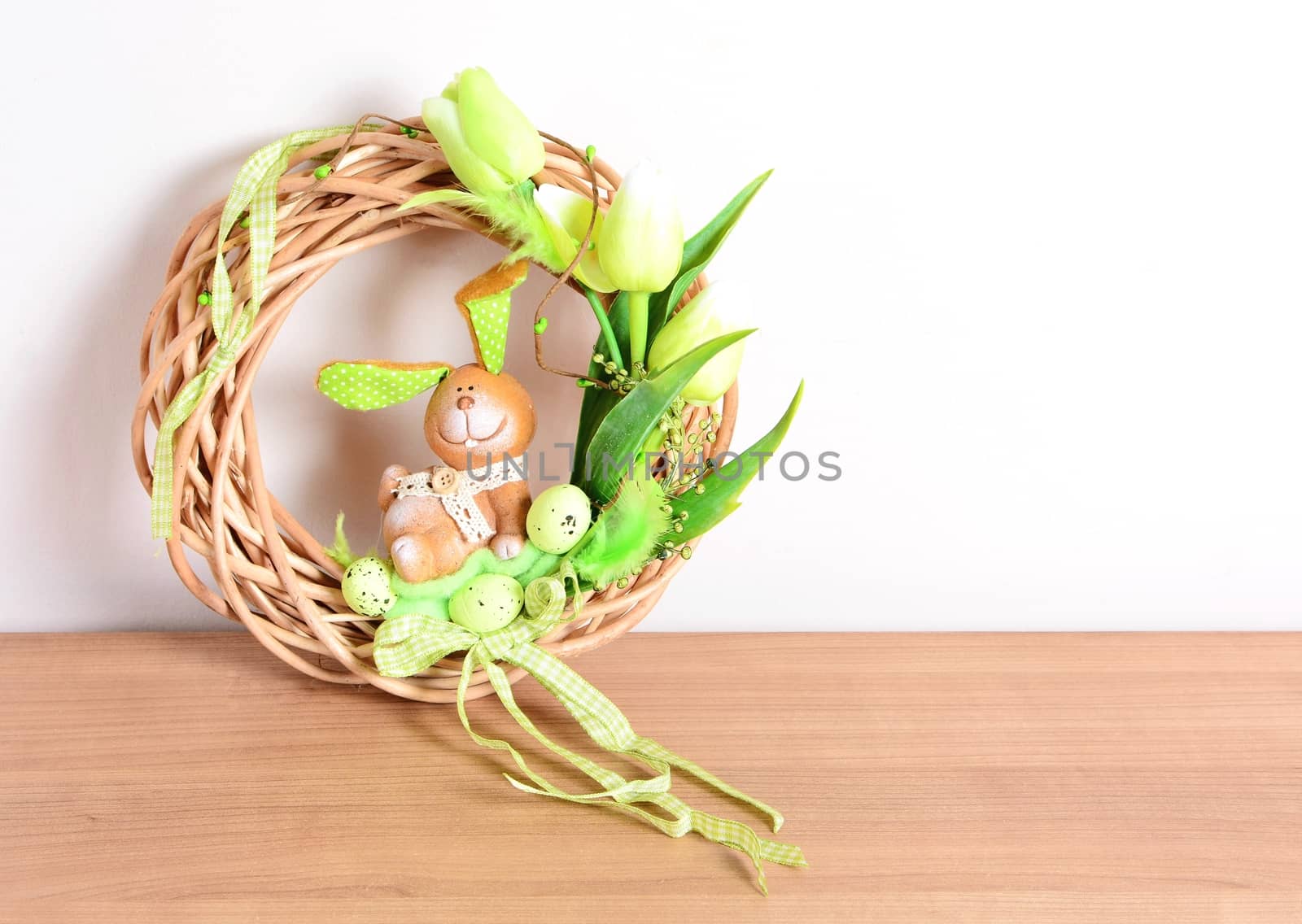 Easter homemade wreath and floral decoration on the table. Homemade arrangement.