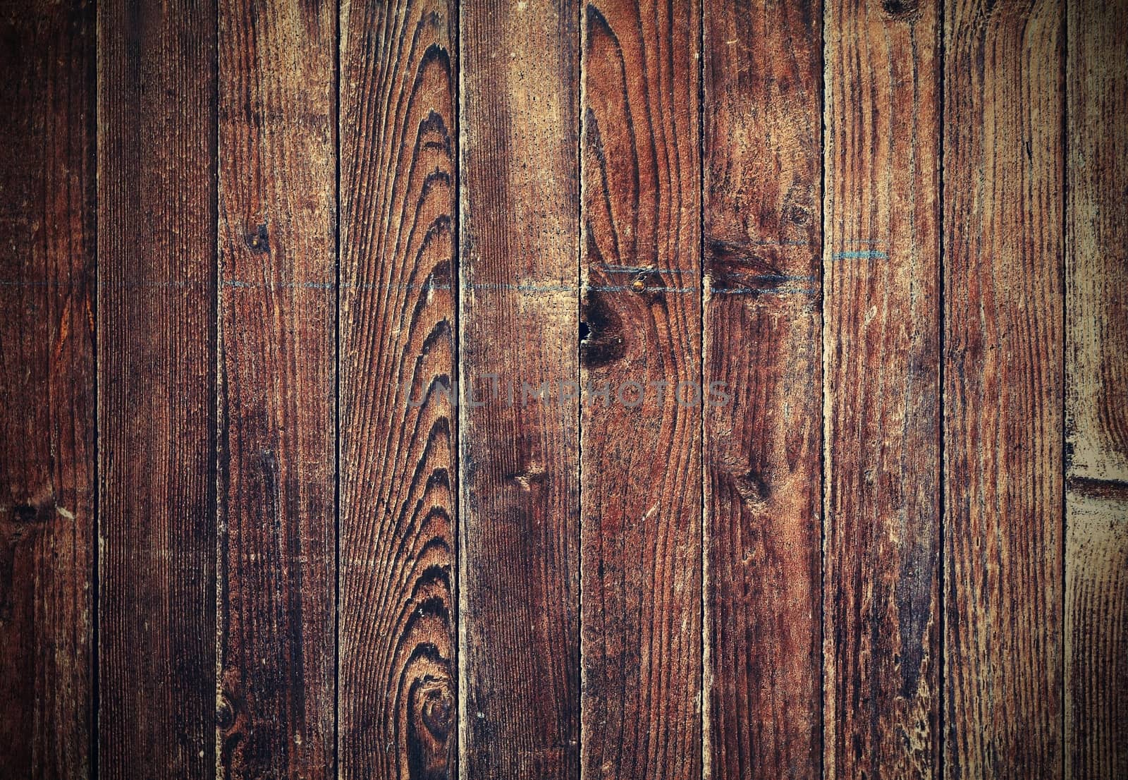 Old dark brown wooden texture with retro color effect and vignetting.