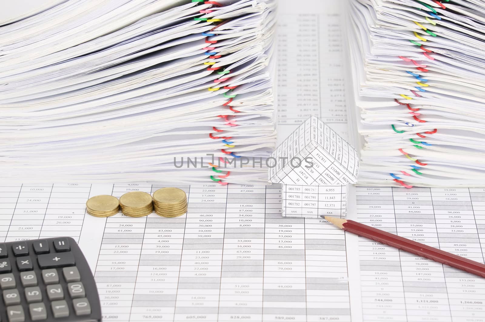 Pencil and house with step pile of gold coins on finance account have calculator and dual pile overload document of report with colorful paperclip as background.