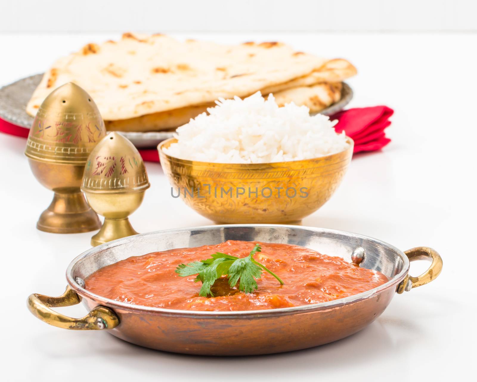 East Indian meal consisting of butter chicken, rice and nan bread.