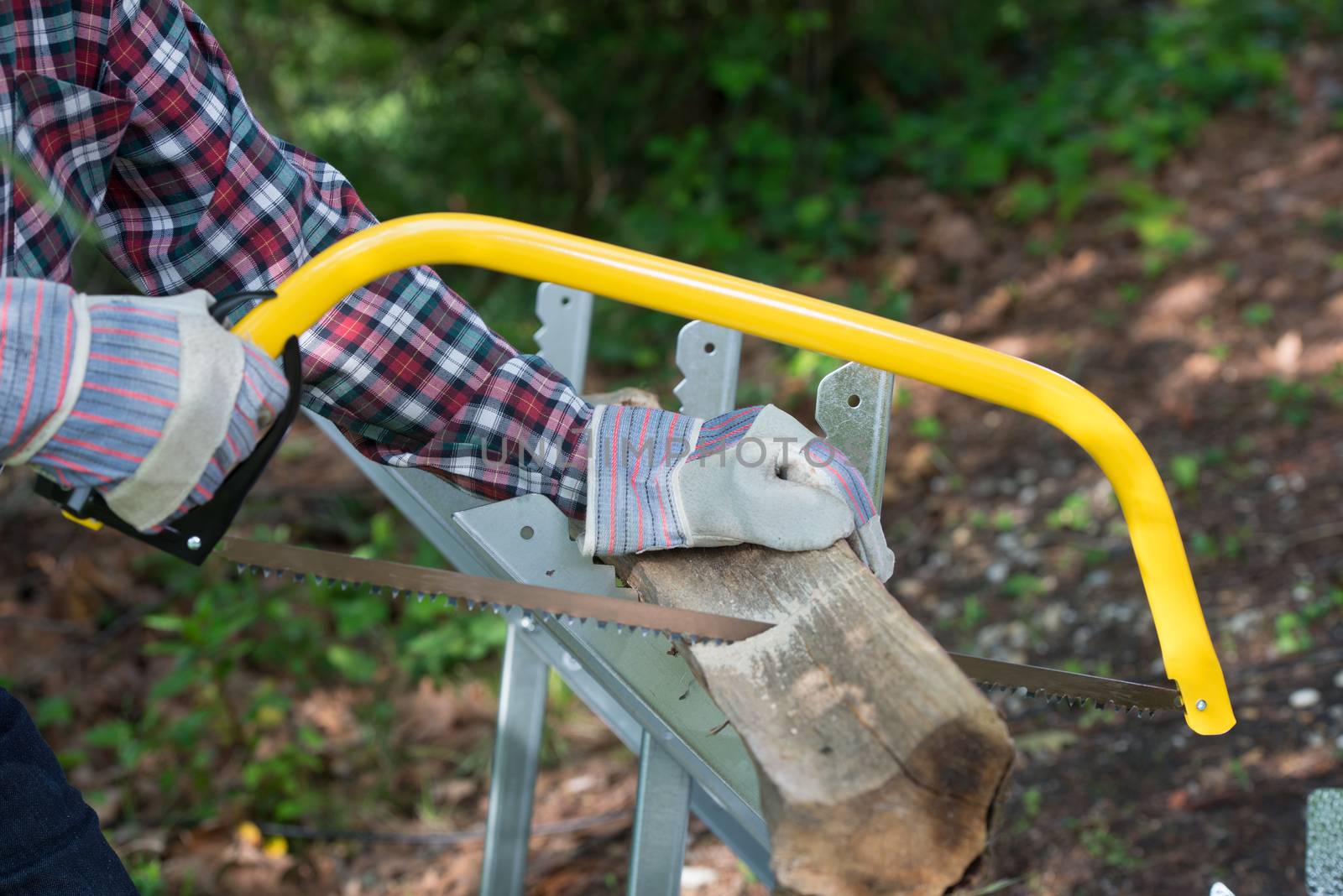 Cropped Hand Of Person Sawing Wood outdoor