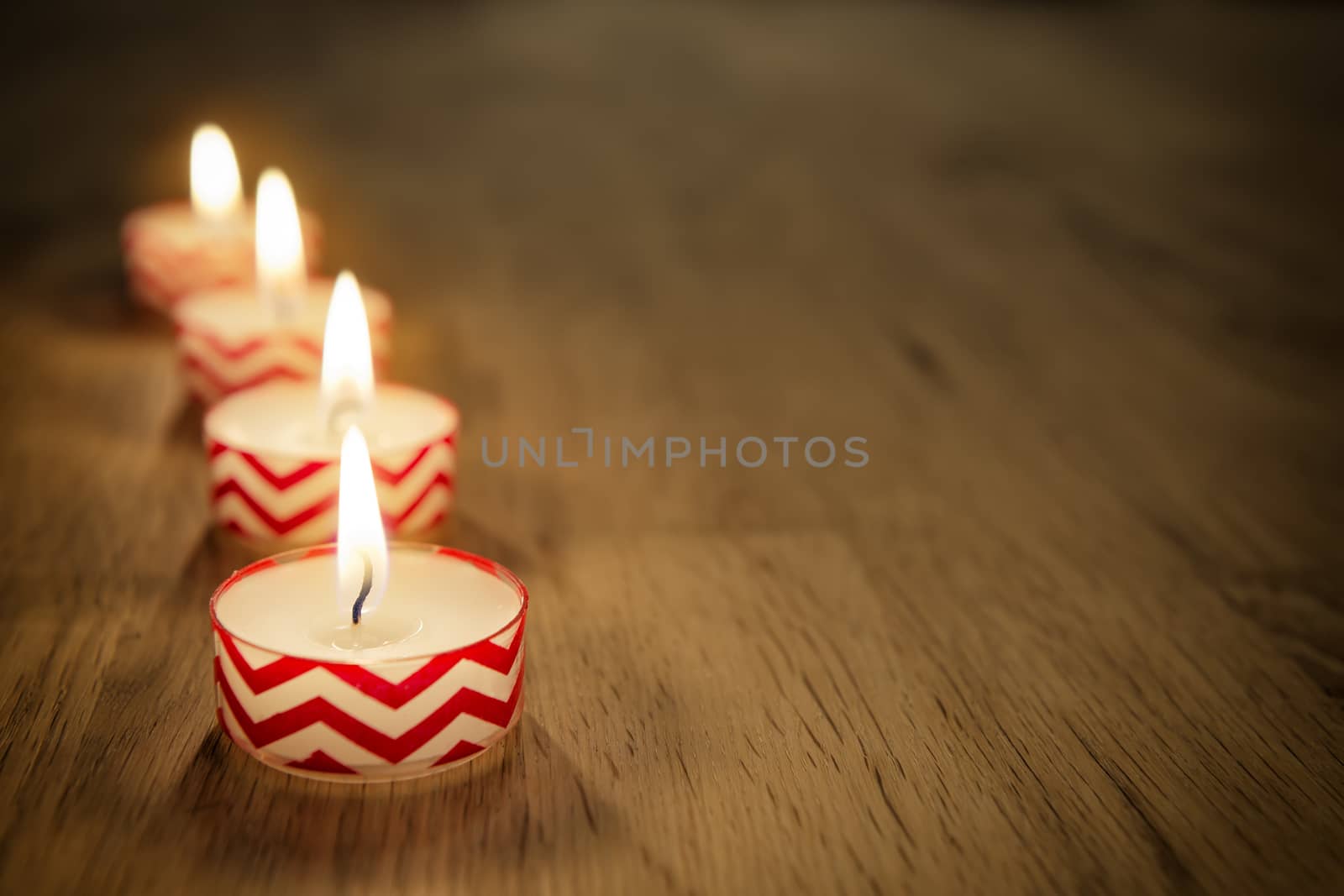 Romantic image of candles on a wooden table