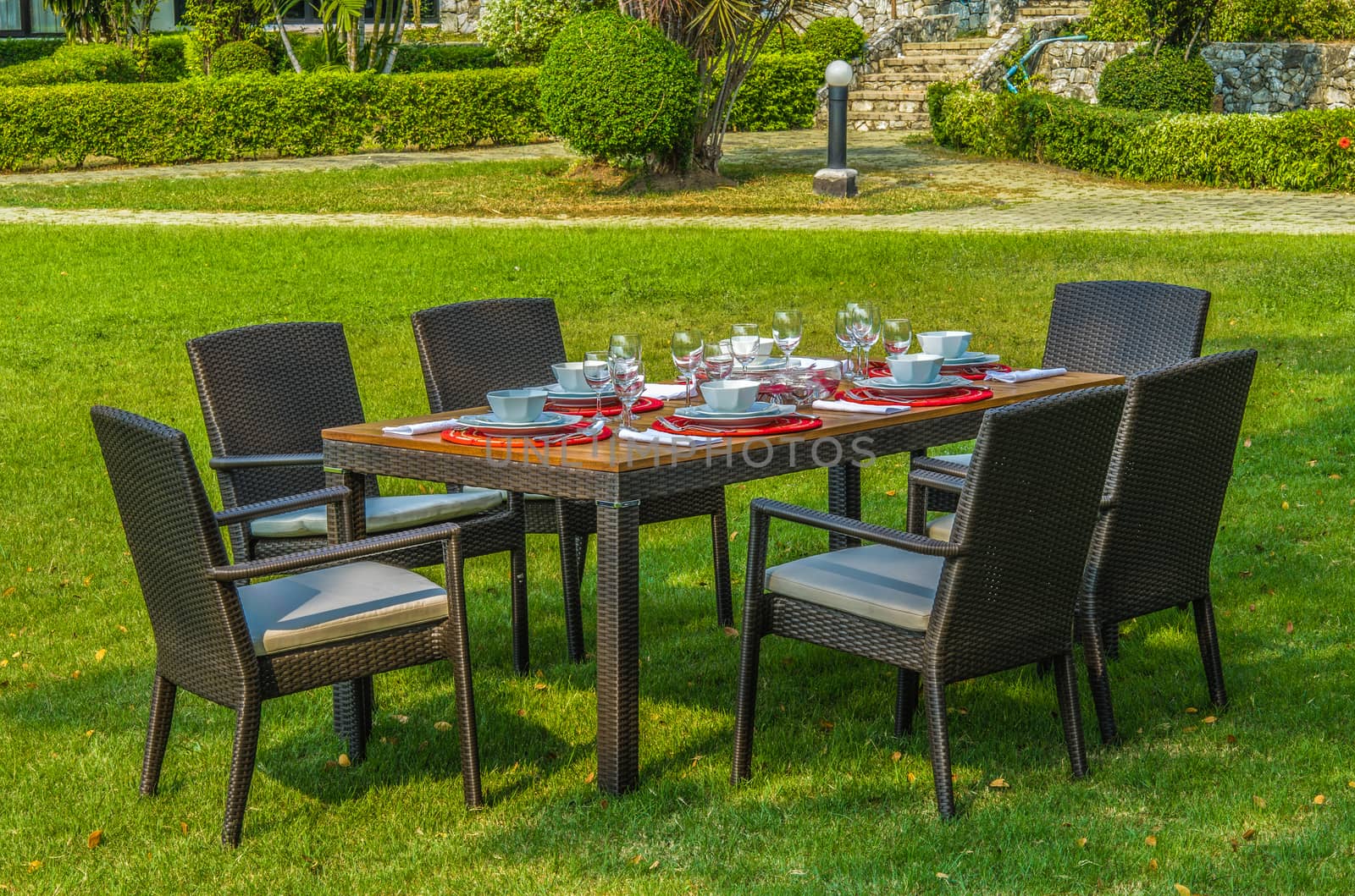 Rattan garden table and chairs  with water resistant outdoor cushions