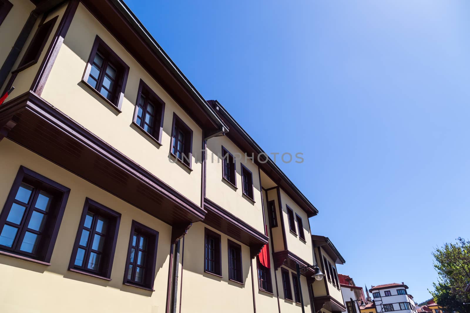 Close up bottom view of historical old colorful Odunpazari houses on bright blue sky background.