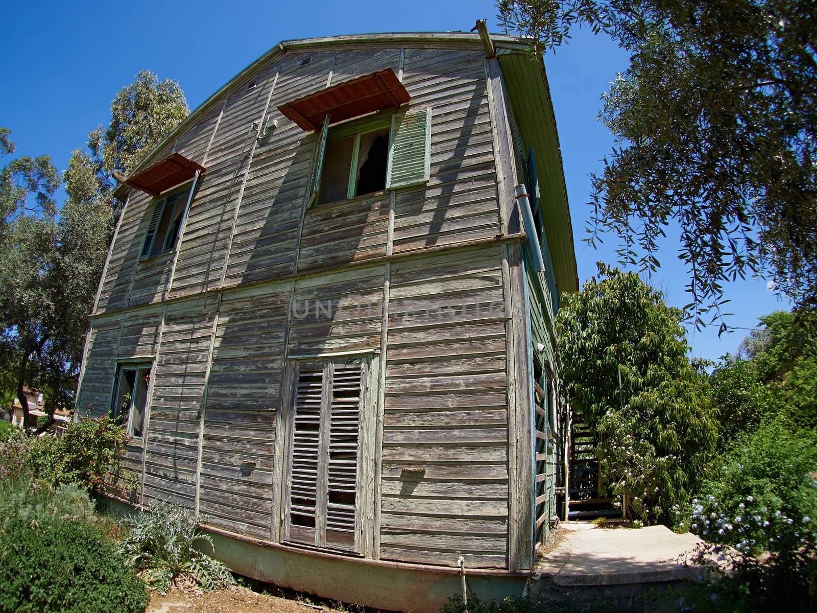 Old weathered abandoned western colonial style wooden house shed