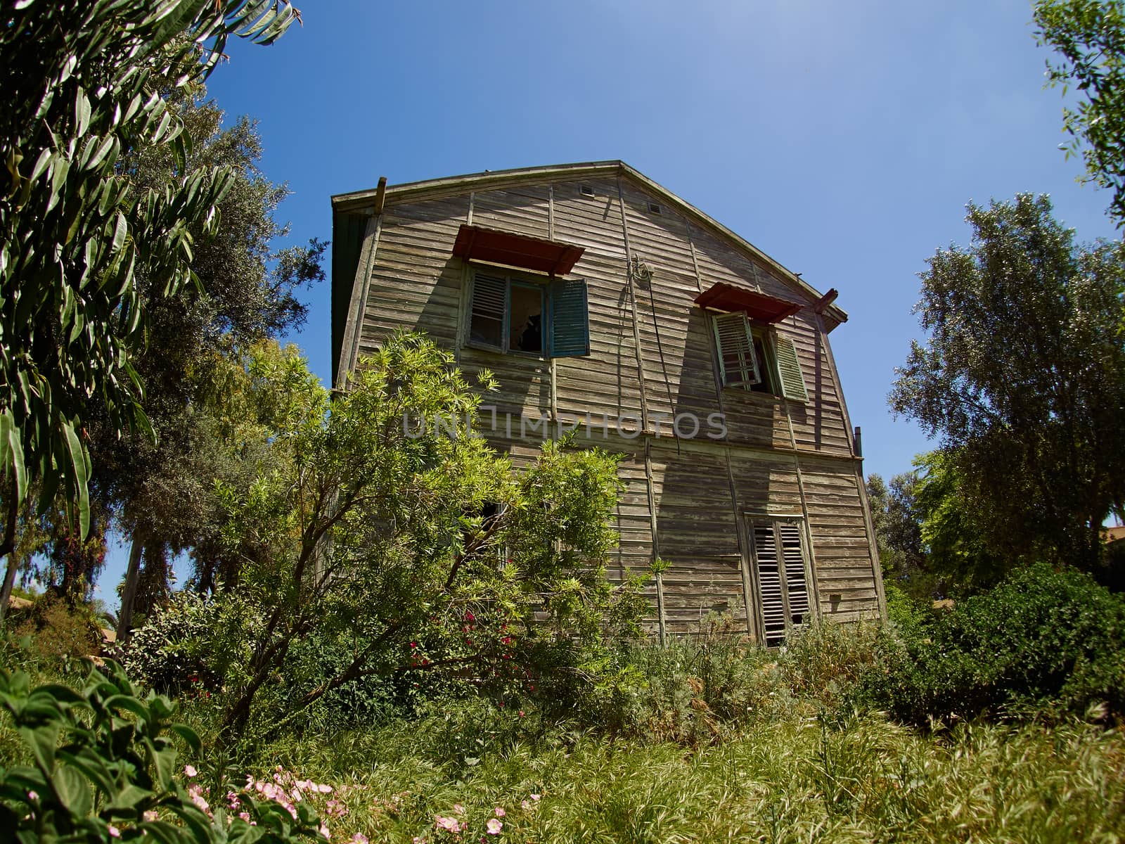 Old weathered abandoned western colonial style wooden house shed