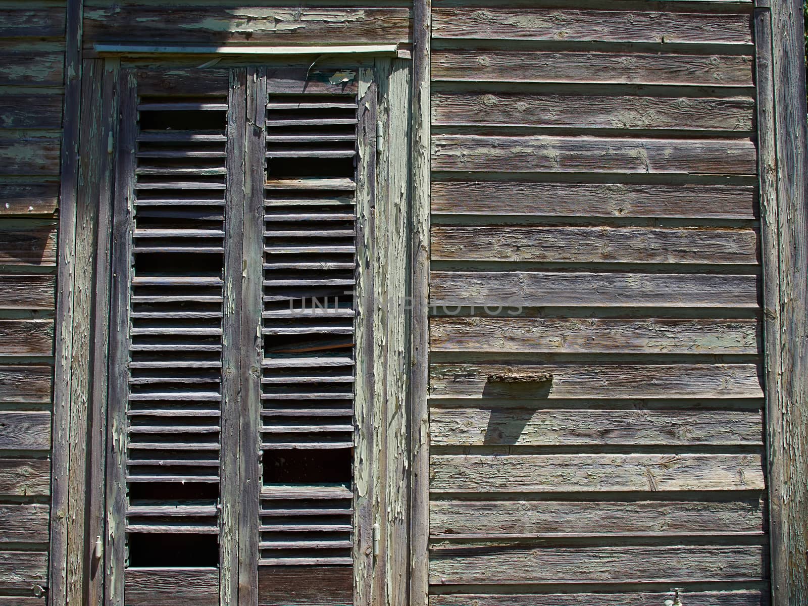 Details of an old weathered abandoned western colonial style wooden house shed