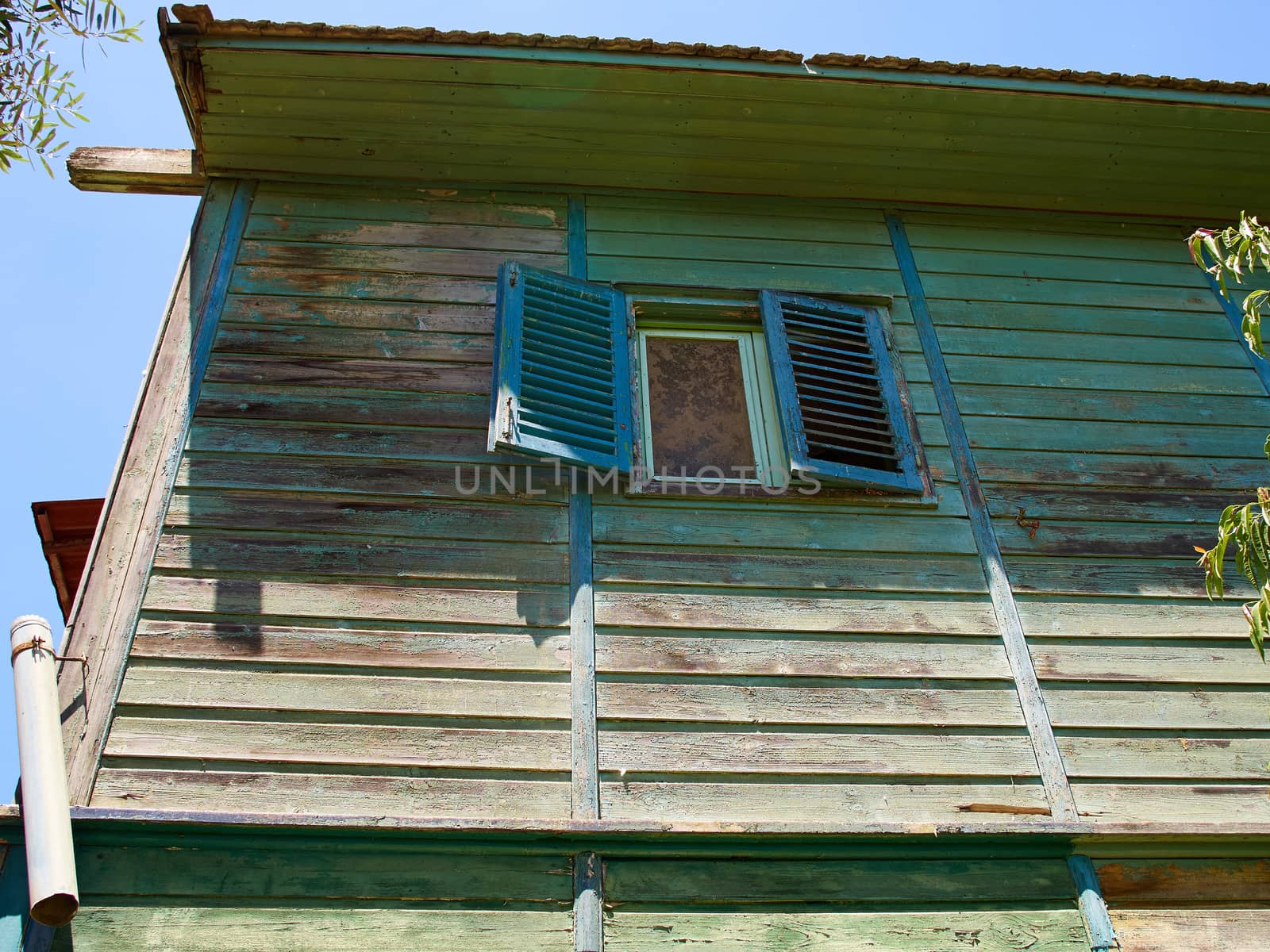 Details of an old weathered abandoned western colonial style wooden house shed