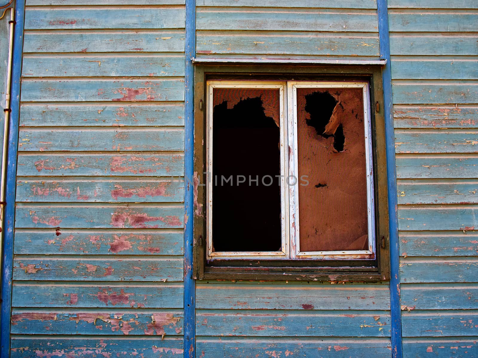 Details of an old weathered abandoned western colonial style wooden house shed