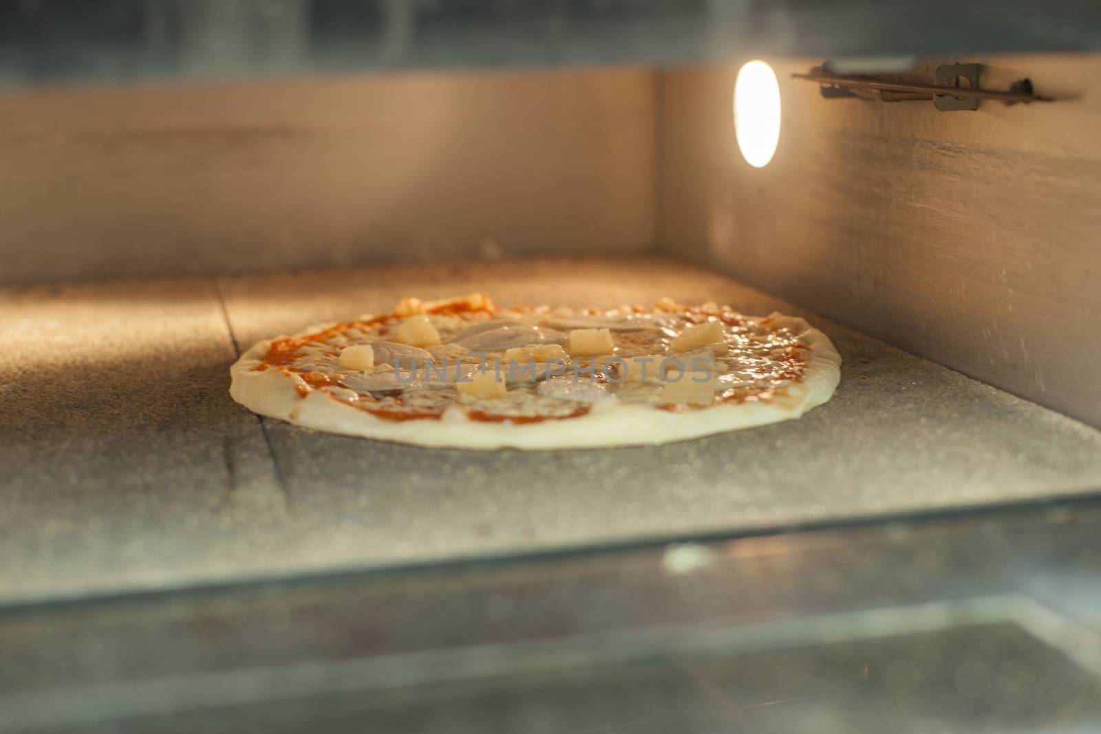 Pizza baking in the oven by kozak