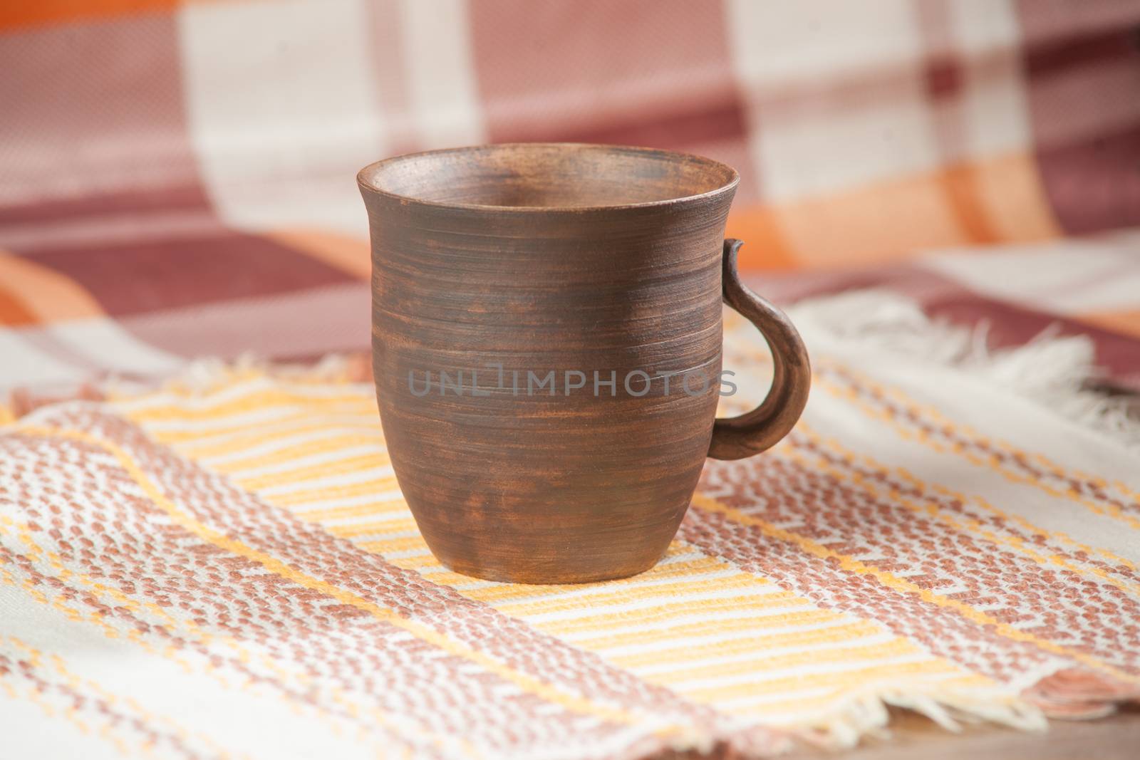 Traditional handcrafted mug on multycolor background. High resolution