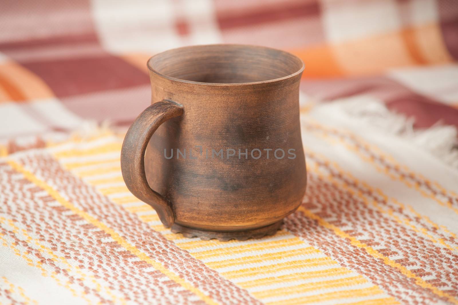 Traditional handcrafted mug on multycolor background. High resolution