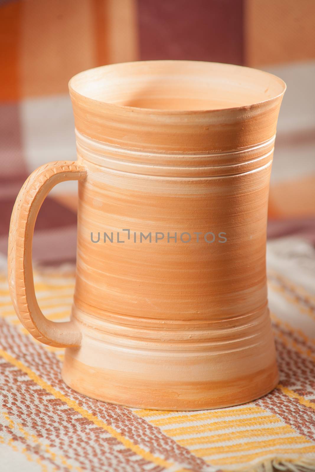 Traditional handcrafted mug on multycolor background. High resolution