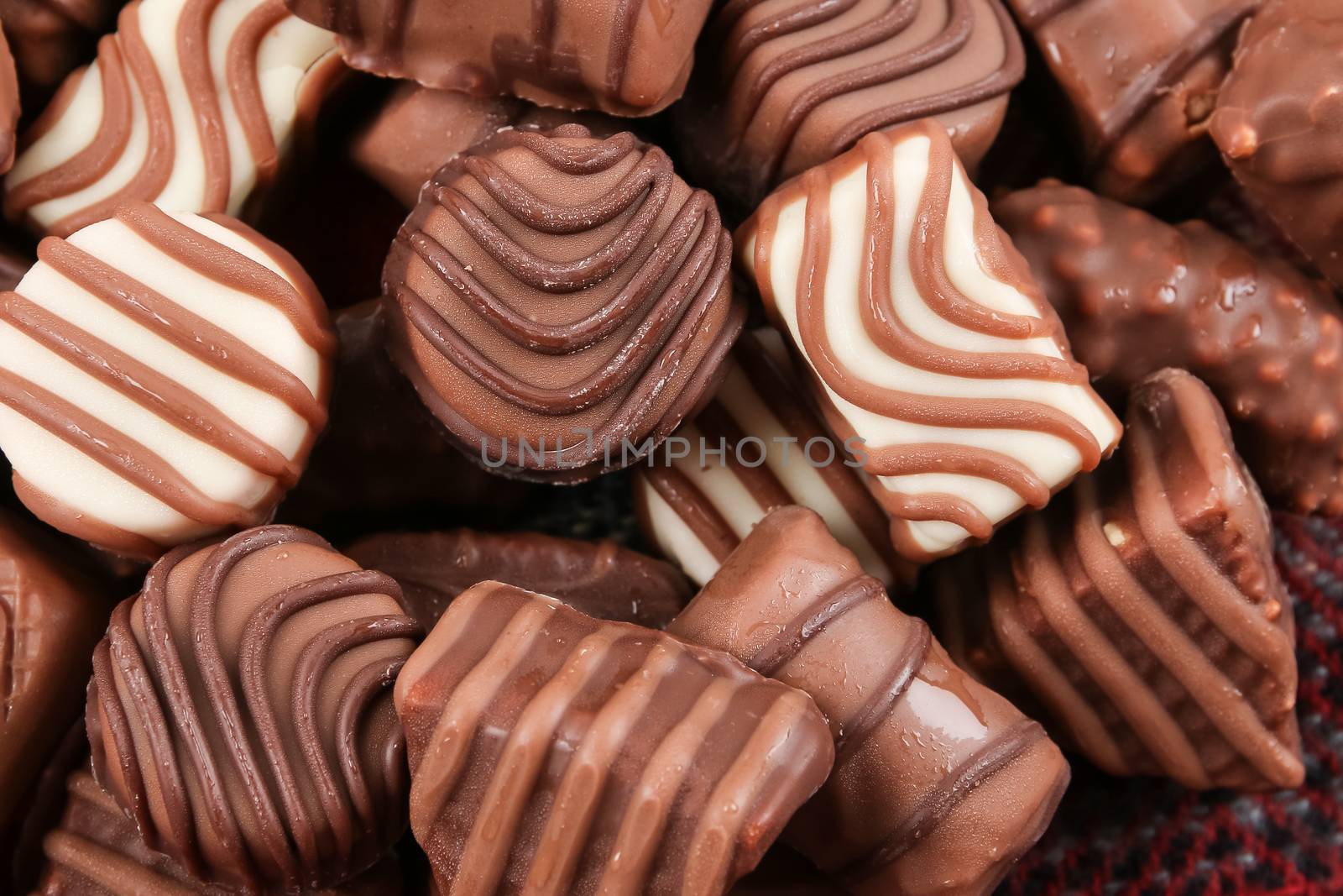 An assortment of fine chocolates in white, dark, and milk chocolate