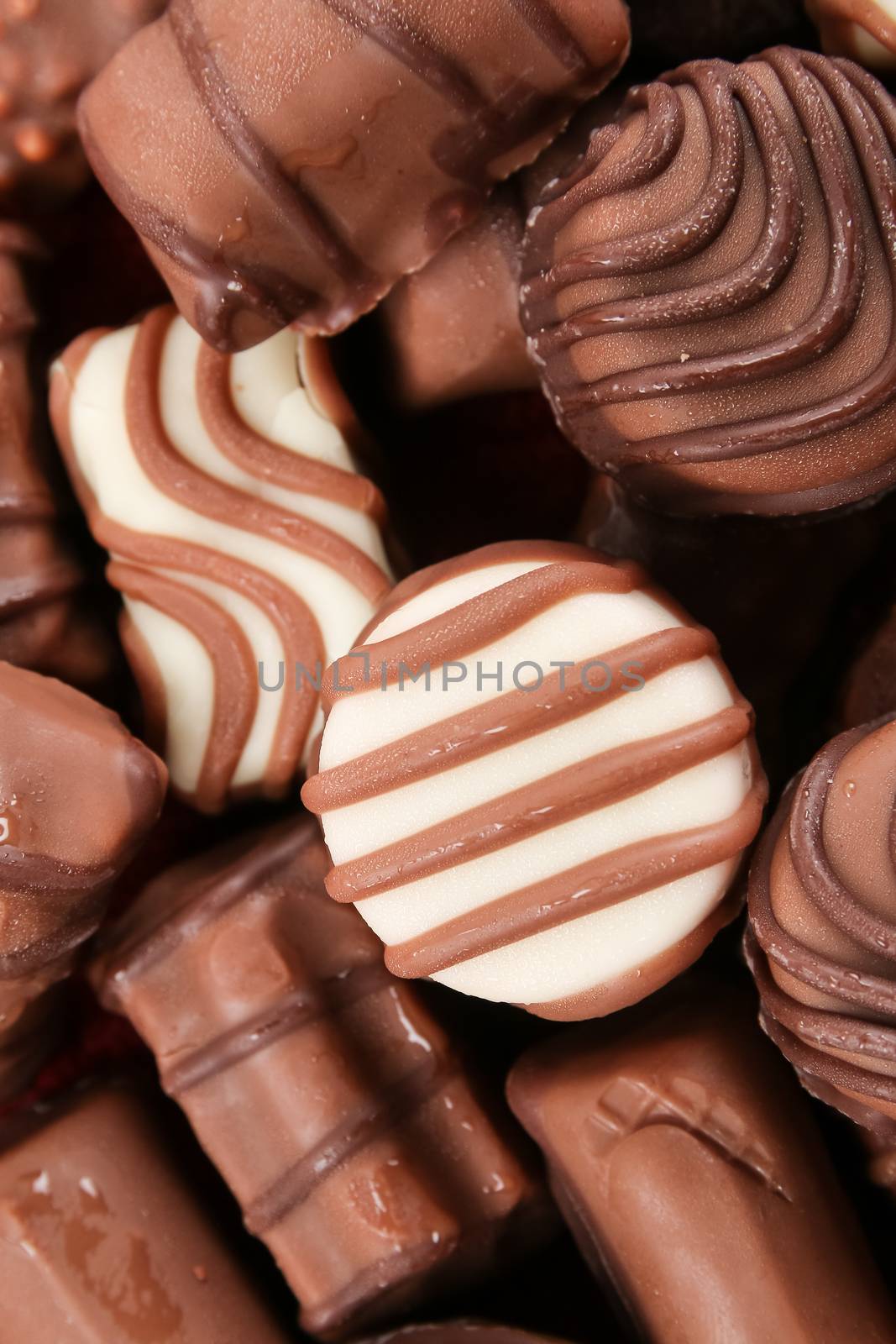 An assortment of fine chocolates in white, dark, and milk chocolate
