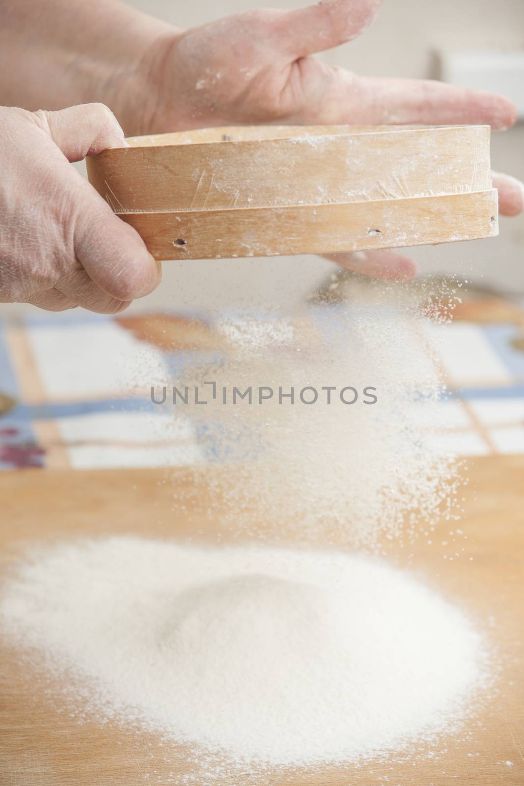 Women's hands preparing flour before baking pie.